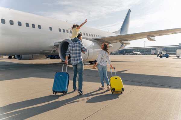 back-view-of-happy-family-standing-near-a-large-plane