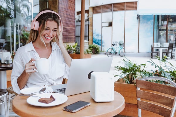 young-latin-woman-using-laptop-and-drinking-coffee-at-restaurant-1