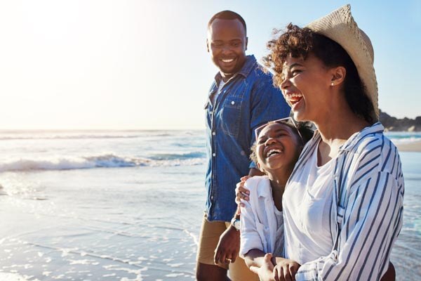 family--travel-and-walking-on-a-beach-with-adorable-child