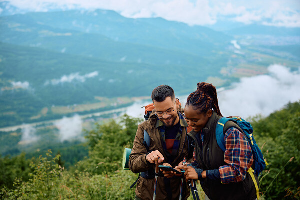 happy-backpacker-and-his-african-american-girlfriend-looking-at-map